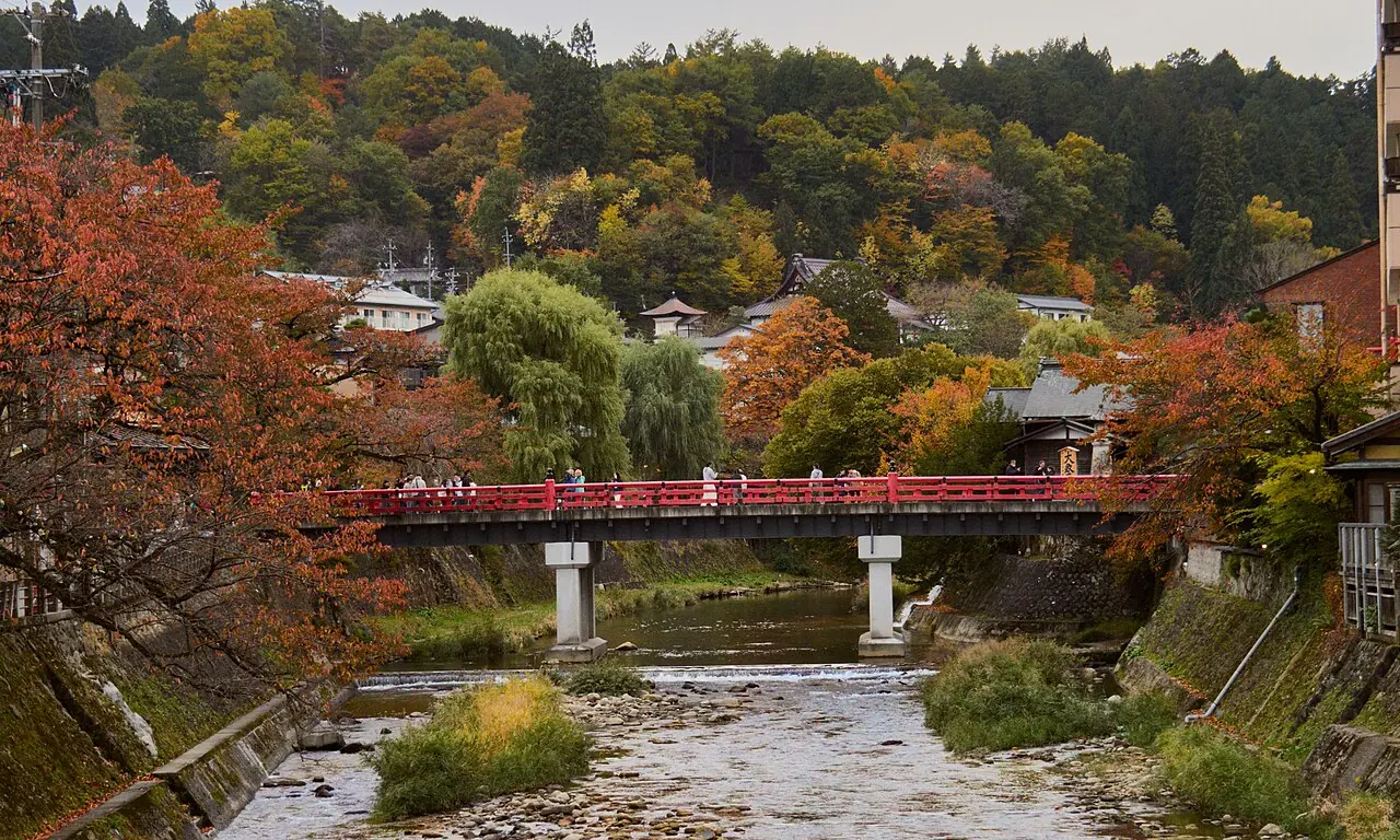 The red Nakabashi bridge over the Miyagawa River in Takayama in autumn