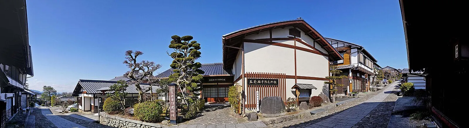 Panorama of houses along the old road in Magome-juku under a blue sky